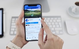 Istanbul, Turkey - December 15, 2018: Person holding a brand new Apple iPhone X with Facebook profile on the screen. Facebook is a social media online service for microblogging and networking, founded in February 4, 2004.